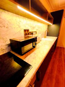 a kitchen with a sink and a counter top at Canal View Lodge & Spa - Entire 3 Bed Lodge in Longford +71 photos