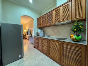 a kitchen with wooden cabinets and a counter top at View Talay Longstay Hotel & Suites in Jomtien Beach