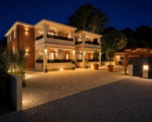 a large building with lights in the night at Apartments Quercus in Vir
