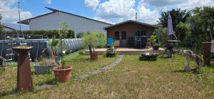 a yard with potted plants and a house at Double room 75 sqm between Augsburg and Munich in Wiedergeltingen