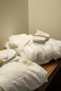 a pile of towels sitting on top of a wooden table at Benedamò Home Inside in Polignano a Mare +111 photos