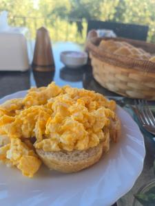 an egg sandwich on a white plate on a table at Five Fingers Holiday Bungalows in Kyrenia
