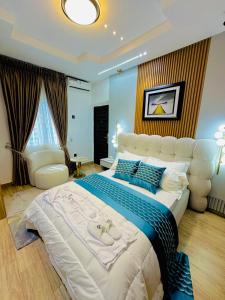 a large bedroom with a large bed and a couch at Armacruz Luxury Hotel And Apartment in Warri Airport