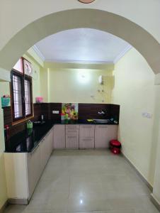 a large kitchen with an archway in a room at 2BHK Flat in Bhimtal in Bhowāli +4 photos