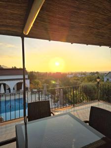 a view of the sunset from the balcony of a house at Five Fingers Holiday Bungalows in Kyrenia +35 photos