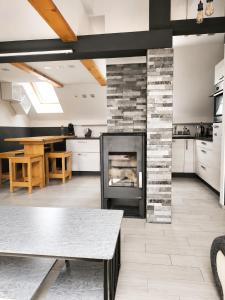 a living room with a fireplace and a table at Apartment Loft Pejić - open space loft studio near Bovec, Soča Valley in Bovec