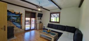a living room with a couch and a table at Holiday Home Emir in Račić