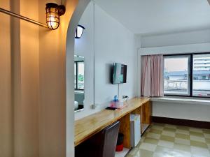 a bathroom with a sink and a mirror at S2S Queen Trang Hotel in Trang
