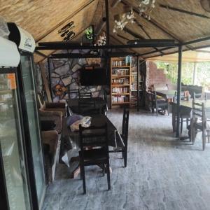 a dining room with tables and chairs in a building at ULA guest house in Ureki