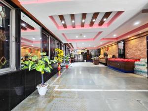 a hallway with plants in a building at Anandaloke Guest House in Kolkata