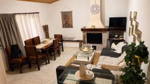 a living room with a couch and a table at All seasons Mountain escape in Vília