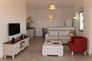 a living room with a white couch and a red chair at Aktur Residence in Bitez