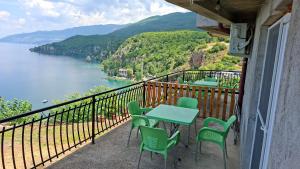 a balcony with a table and chairs and a view of the water at Apartments Viktor in Trpejca