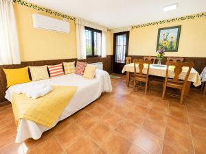 a room with two beds and a table and chairs at Casa La Bienvenida con patio y aparcamiento - Apartamentos Aloha Toledo in Nambroca