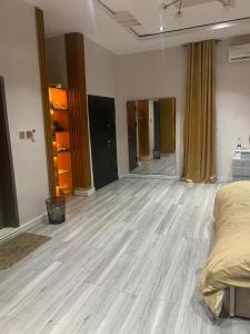 an empty room with a bed and a wooden floor at Polsh residence in Lekki