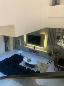 a living room with a couch and a tv at Polsh residence in Lekki