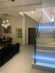 a staircase in a living room with a blue light at Polsh residence in Lekki