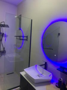 a bathroom with a sink and a glass shower at Polsh residence in Lekki