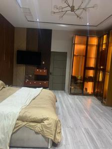 a bedroom with a bed and a large mirror at Polsh residence in Lekki