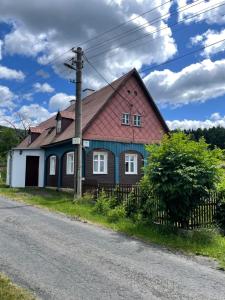 a house with a red roof on the side of a road at House Pankraz Jitrava in Rynoltice