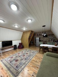 a large living room with a table and a rug at Borjomi Tskhaoba in Borjomi