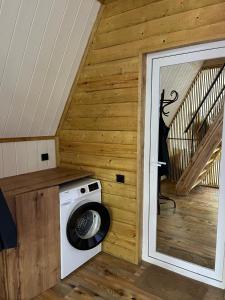 a washing machine in a room with a staircase at Borjomi Tskhaoba in Borjomi