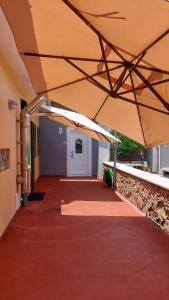 an empty hallway of a building with a large umbrella at Emerald House in Augusta in Augusta