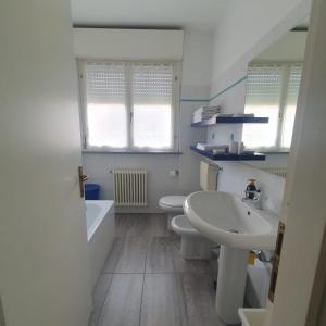 a bathroom with two toilets and a sink and a tub at CASA VACANZE Matilde in Gavirate +49 photos