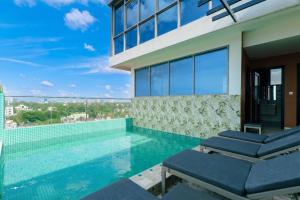 a swimming pool with a view of a building at Abantu Hotel in Dar es Salaam