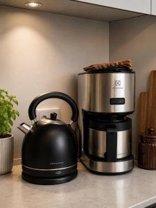 a slow cooker and a tea kettle on a kitchen counter at JG-Central Apartment Odense C in Odense