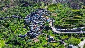 an aerial view of a village with houses and a road at Casas Martinho - O Baloiço in Piódão