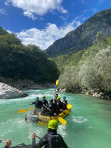 a group of people on a raft in a river at Apartment Loft Pejić - open space loft studio near Bovec, Soča Valley in Bovec