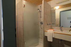 a bathroom with a shower and a sink at Edelweiss 209 - Typ B in Fontanella