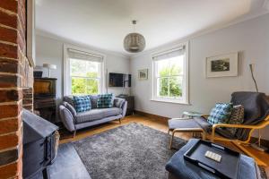 a living room with two chairs and a couch at Forest View in Brockenhurst