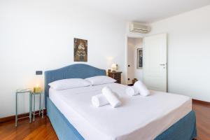 a bedroom with two beds with white pillows at Hostdomus - Brezza Marina House in Alassio +21 photos