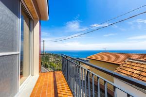 a balcony with a view of the ocean at Hostdomus - Brezza Marina House in Alassio