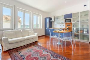 a living room with a couch and a table at Hostdomus - Brezza Marina House in Alassio