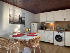 a kitchen with a table and chairs in a kitchen at Vila Hedona in Donji Milanovac
