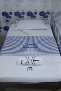 a bed with two pillows on top of it at Hotel Eswara Temple Stay in Kumbakonam