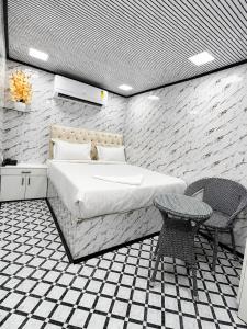 a bedroom with a bed and a table and chairs at Cannaught Stays in New Delhi