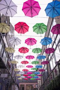 a bunch of umbrellas flying in the air at The Dawson Hostel - DUBLIN in Dublin