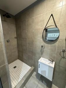 a bathroom with a sink and a mirror at Sir Galahad Flatlet 2 in Camelot in Silver Sands