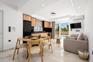 a living room with a table and a couch at Paradise Garden Villa in Moírai