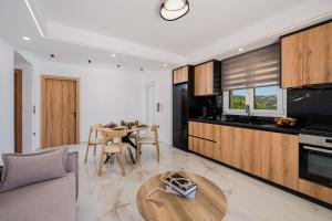 a living room with a table and a kitchen at Paradise Garden Villa in Moírai +38 photos