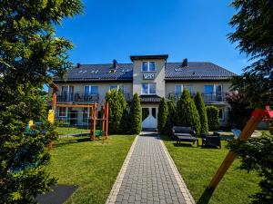 a large house with a garden in front of it at Willa Ibis in Karwia