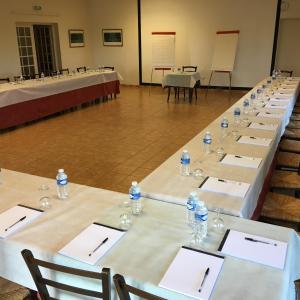 a row of tables with bottles of water on them at Logis Hôtel Les Nymphéas in Chaufour-lès-Bonnières