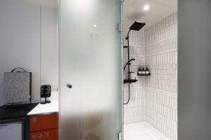 a bathroom with a shower and a sink at Hotel RUGO in Jeonju
