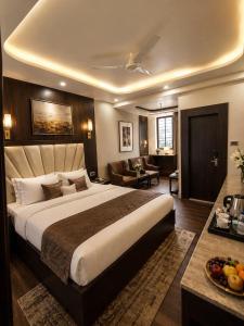 a bedroom with a large bed and a living room at Hotel Rudransh in Rānchī