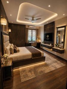a bedroom with a large bed and a television at Hotel Rudransh in Rānchī