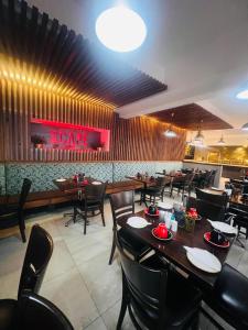a dining room with tables and chairs and a restaurant at Innscape Classic Hotel in Cape Town